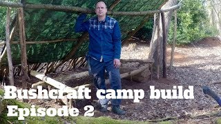 Bushcraft camp build episode 2 making the roof waterproof, building a wall, lunch on a twig stove
