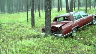 Crash testing the rear of a 1984 Cadillac Fleetwood Brougham d'Elegance into a fixed barrier.