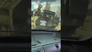 Ukrainian civilians throw Molotov cocktail at a passing Russian military vehicle