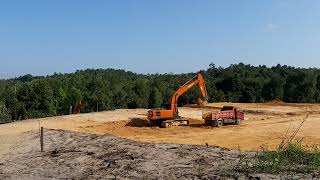 Excavator and Dumptruck work together to finish cut and fill works