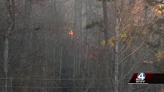 Crews work to contain wildfire as winds begin to calm down in North Carolina