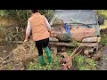 a girl walking across a stream saw a ford transit buried underwater.