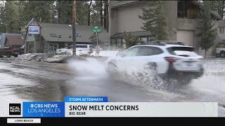 Residents rush to stop the melting snow from flooding their San Bernardino homes