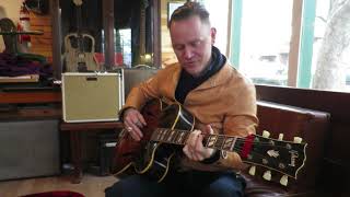 CW Stoneking testing his repaired Gibson archtop guitar.