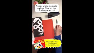 Grace Lin makes a paper cut for the Year of the Snake