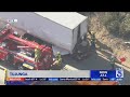 2 dead as car crashes into big rig