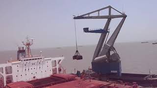 FIGEE crane discharging coal from Capsize vessel at Bedi anchorage, Jamnagar