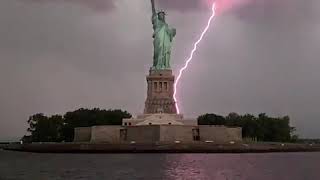 Statue of Liberty lit up by lightning