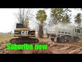 excavator cat 312 loading dump truck near bamboo