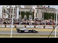 Mika Hakkinen McLaren MP4/13 formula one car drive past at the Goodwood Festival of Speed 2023