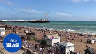 People soak up the rays on Brighton beach amid heatwave weather