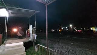 Pothigai Express of Indian Railways thundering past a railway crossing in Madurai TN.