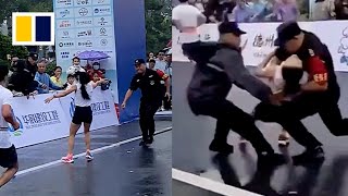 Quick-thinking security guard catches collapsing marathon runner