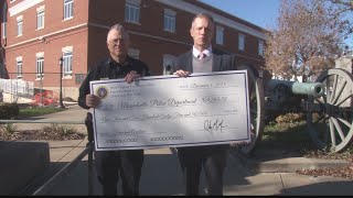 Local police department receives check from state gun auction