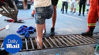 Painful moment girl gets leg stuck in sewer drain in China