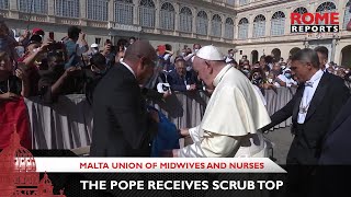 Nurses and midwives from Malta give Pope Francis scrub top signed by medical staff