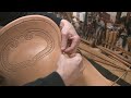 leather working hand sewing and stitching a leather saddle