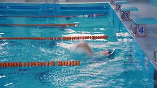 Technique of turning around in the water by pushing off the wall of the pool. Swimmer man swims