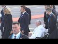 Pope Francis with Emmanuel and Brigitte Macron at the airport | AFP