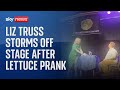 Liz Truss storms off stage after lettuce banner prank