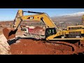 caterpillar 365c excavator loading trucks with three passes