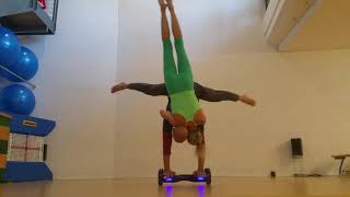 Upside Down Woman Holds Onto Guy as He Performs Handstand on Hoverboard - 1244843