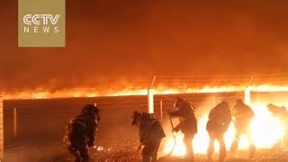 Chinese residents flee as massive fire spreads from Russia