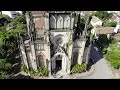 🏰 4k aerial tour of a gothic church in a verdant neighborhood drone