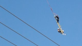 Crazy Helicopter ride for linemen hanging from ladder