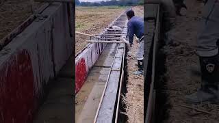 Construction worker remove concrete drainage ditch mold