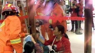 Chinese firemen rescue boy stuck between glass doors
