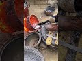 Craftsman casting aluminum pots on the street