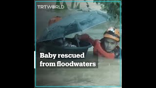 Coast guards save baby from floodwaters