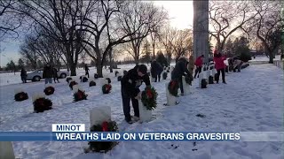 Volunteers place wreaths on veterans’ gravesites in Minot
