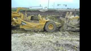 Cat 631G Scrapers Pushed by D-10 Dozer