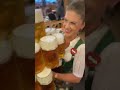 oktoberfest waitress carries 13 beer mugs