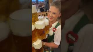 oktoberfest waitress carries 13 beer mugs