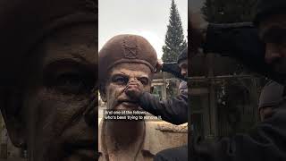 Garbage men remove al-Assad statue in Damascus