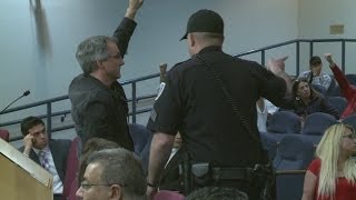 7 silent protesters escorted out of council meeting