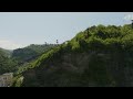 rusty material ropeway with cargo containers above rock cliff georgia free stock video