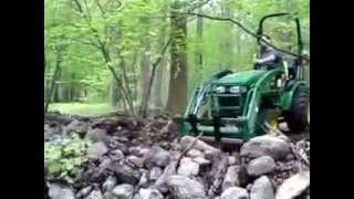 John Deere 2520 using Artillian Forks to dismantle old stone wall