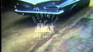 U.S. car passes displaying fins.  Archive film 93328