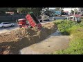 perfect new action dump truck 5t unloading soil filling up with technique operator bulldozer working