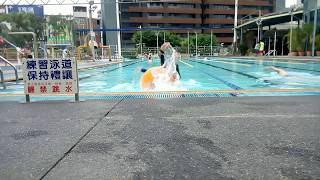 Clumsy boy fall into pool in wetsuit