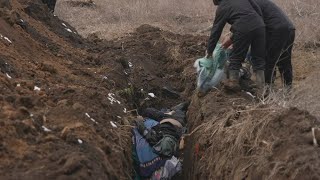 GRAPHIC: Bodies buried in mass grave in Mariupol