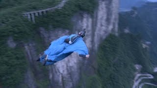 Feel the thrill! Wingsuit pilot latches on paraglider in midair in China