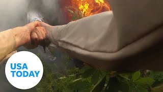 Deputy smashes window, pulls driver from burning car in dramatic rescue | USA TODAY