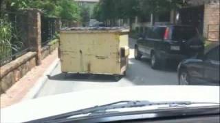 WTF?!?  Dumpster rolling down the street