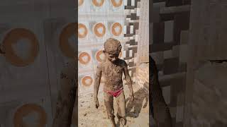 Indian kid Enjoying Mud Bath