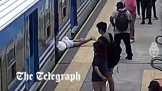 Shocking CCTV shows woman narrowly avoiding death as she falls into moving train in Argentina